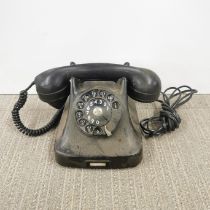 An unusual black bakelite telephone.