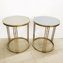 A pair of curcular gilt metal, mirror topped side tables, H. 61cm Dia. 50cm.