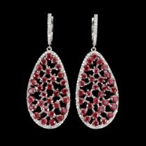 A pair of 925 silver long drop earrings set with round cut rubies, L. 5.2cm.