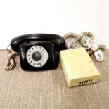 A vintage black telephone and bell.