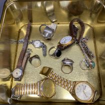 A tin of mixed interesting items including watches and jewellery.