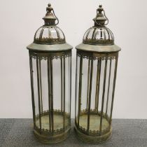 A pair of large metal and glass garden storm lanterns, H. 88cm.