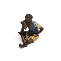 A Vienna style cold painted bronze figure of a boy smoking a pipe.