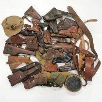 A quantity of mixed gun holsters and other items.