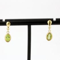 A pair of 9ct yellow gold drop earrings set with oval cut peridot, L. 1.8cm.