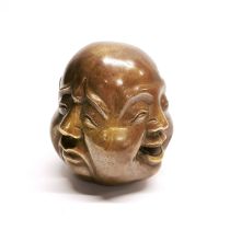 A Chinese four faced bronze paper weight, H. 11cm.