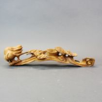 A Chinese hand carved root wood ruyi sceptre decorated with bats, L. 40cm.