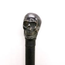 A bronze skull handled walking stick with wooden shaft, H. 76cm.