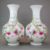 A pair of Chinese porcelain vases decorated with bats and peaches with four character mark to