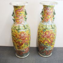 A very large pair of Chinese glazed relief decorated porcelain vases decorated with dragons
