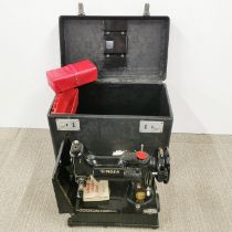 A cased Singer sewing machine.