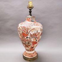 An early 20thC Japanese hand painted porcelain table lamp, base mounted on a gilt metal foot, H.