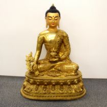 A large Tibetan gilt bronze Buddha with temple quality painted head, H. 71cm.