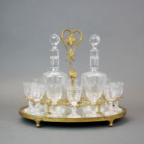A gilt metal liquor set comprising two decanters and twelve glasses, H. 28cm.