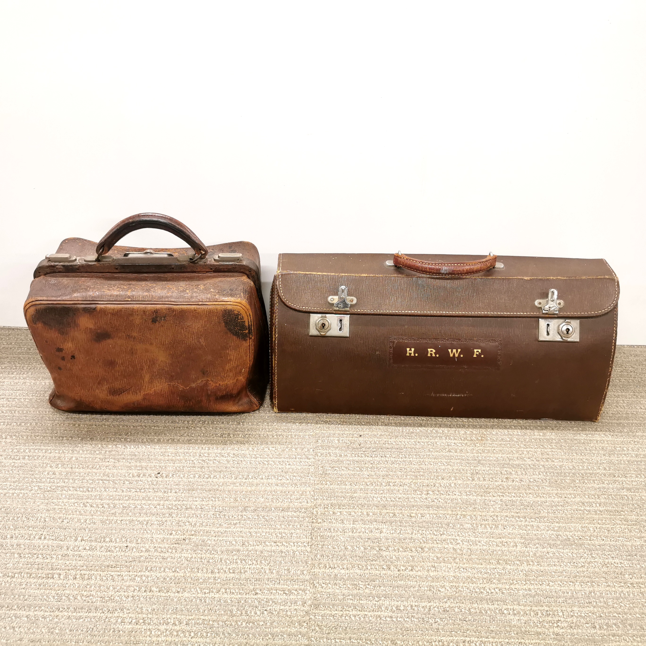 An antique leather Gladstone bag and a further antique travelling bag, W. 30cm.