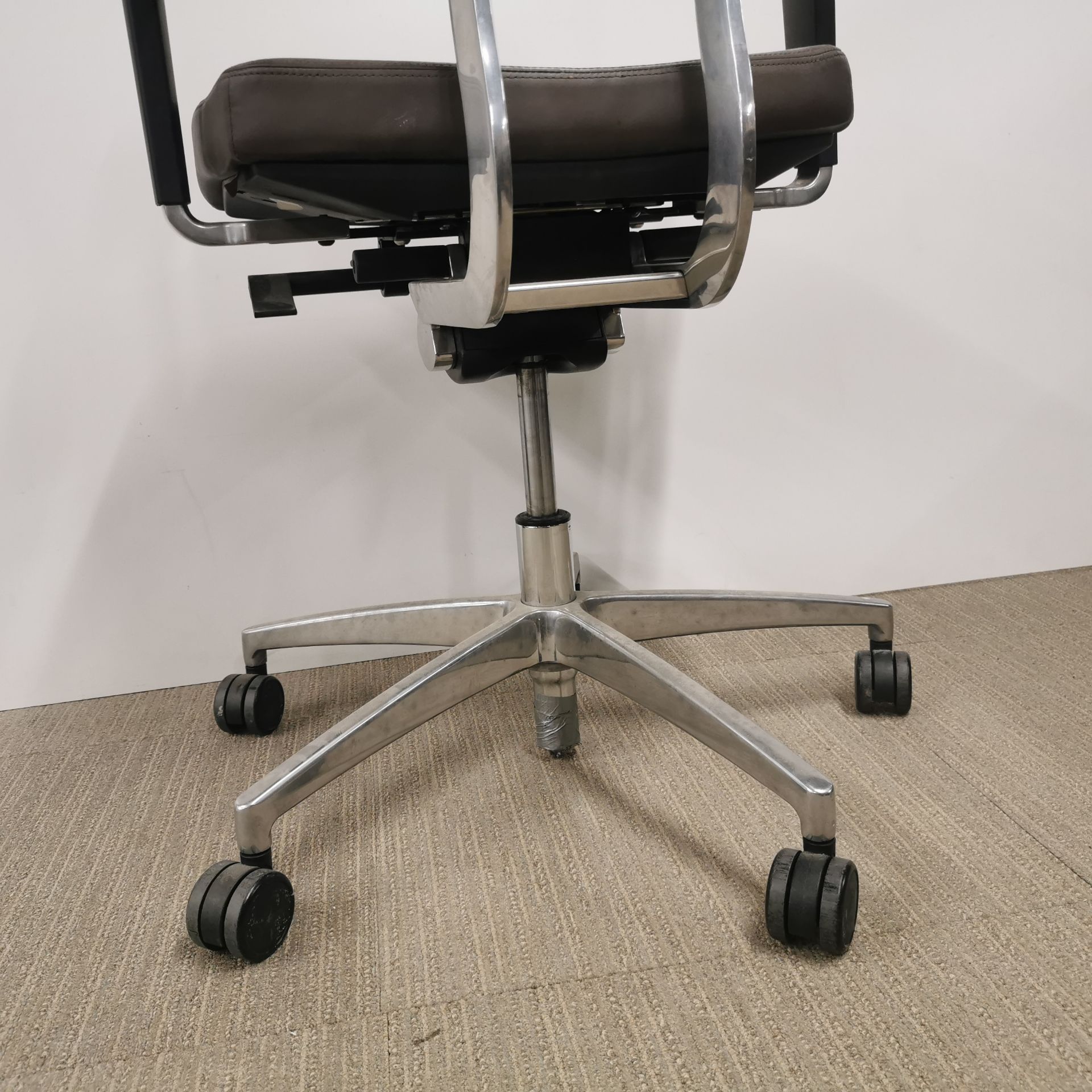 An adjustable faux leather and chrome revolving desk chair. - Image 3 of 4