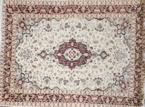 An eastern cream, beige and red ground wool rug, 280 x 185cm.