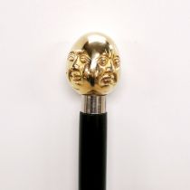 A four headed brass handled walking stick, L. 92cm.