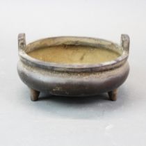 A Chinese cast bronze three footed censer, H. 6cm, dia. 14.5cm.