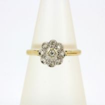 A hallmarked 18ct yellow and white gold diamond cluster ring, (N).