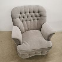A button backed grey upholstered armchair, H. 82cm.