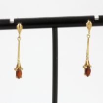 A pair of hallmarked 9ct yellow gold drop earrings set with marquise cut garnets, L. 3cm.