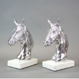 A pair of silverplated horse head book ends on marble bases, H. 24cm.