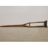 An early brass wood and leather crutch.