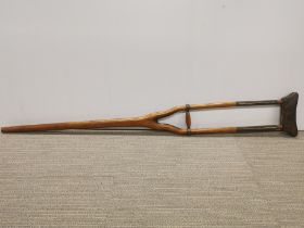 An early brass wood and leather crutch.