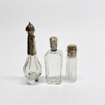 A group of three silver topped perfume bottles