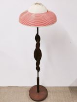 A 1970's teak and brass lamp, H. 124cm. Together with a 1950's plastic ceiling shade.
