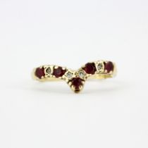 A hallmarked 9ct yellow gold ruby and diamond wishbone ring, (K.5). With 9ct gold ring adjuster