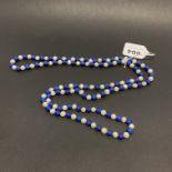 A single strand necklace of freshwater pearls and lapis lazuli beads, L. 120cm.