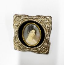 A hand painted miniature of a lady set into an Art Nouveau style silver frame, 8 x 8cm