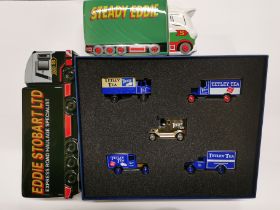 A boxed set of Tetley T diecast model vans and two ceramic money boxes.