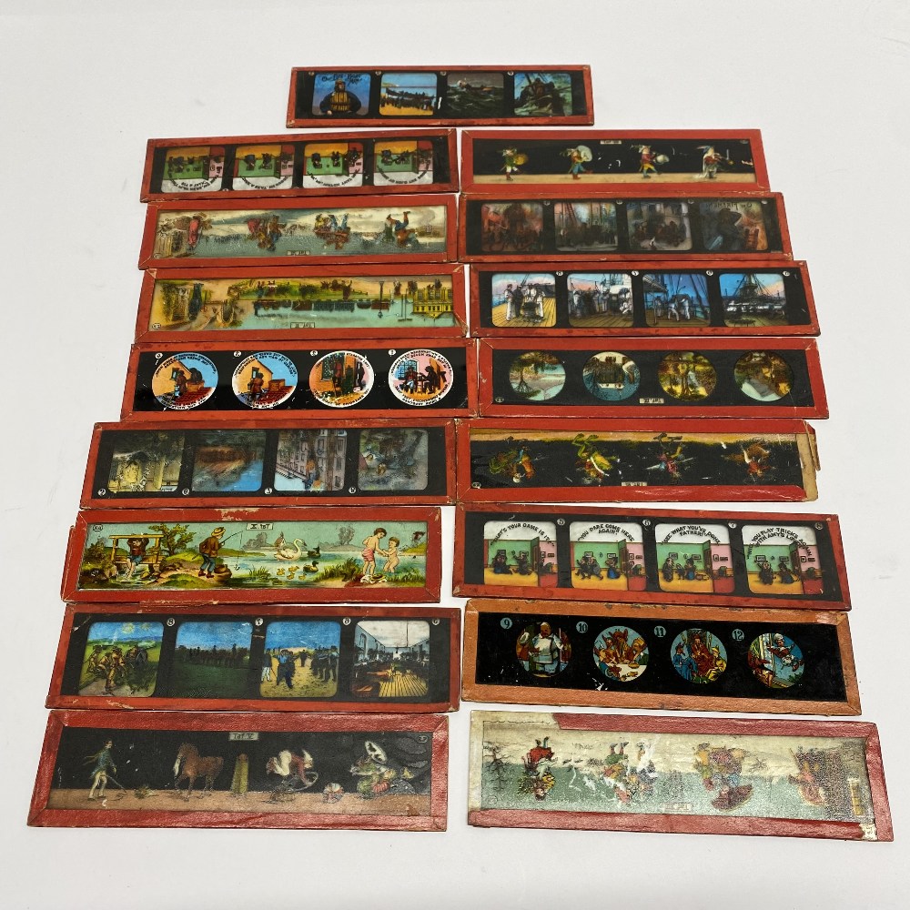 A quantity of hand coloured glass magic lantern slides.