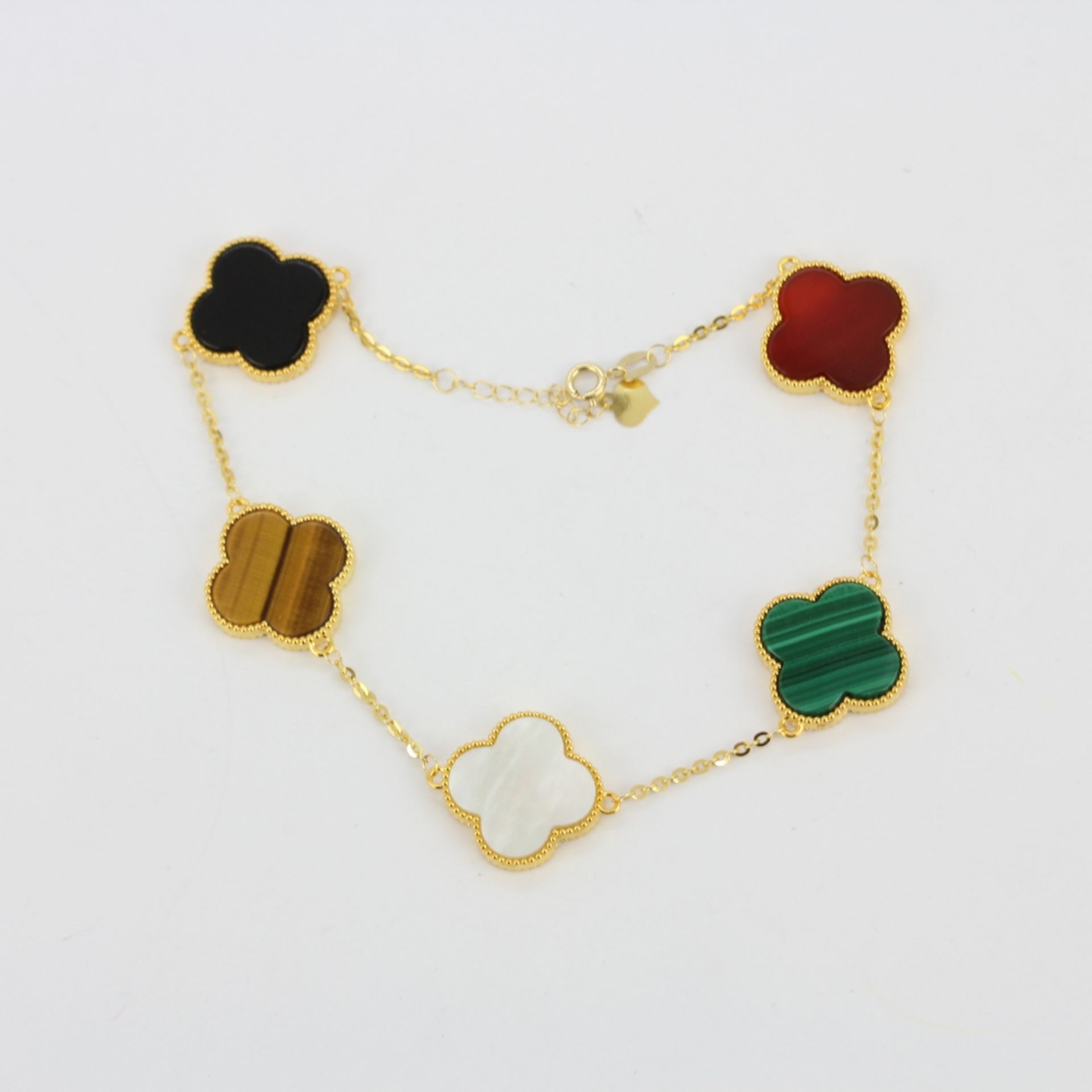 An 18ct yellow gold clover bracelet set with carnelian, malachite, tiger's eye, onyx and mother of - Image 2 of 3