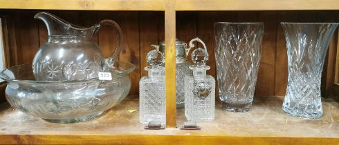 An Edwardian cut glass jug and bowl set, together with two cut crystal decanters, a water jug and