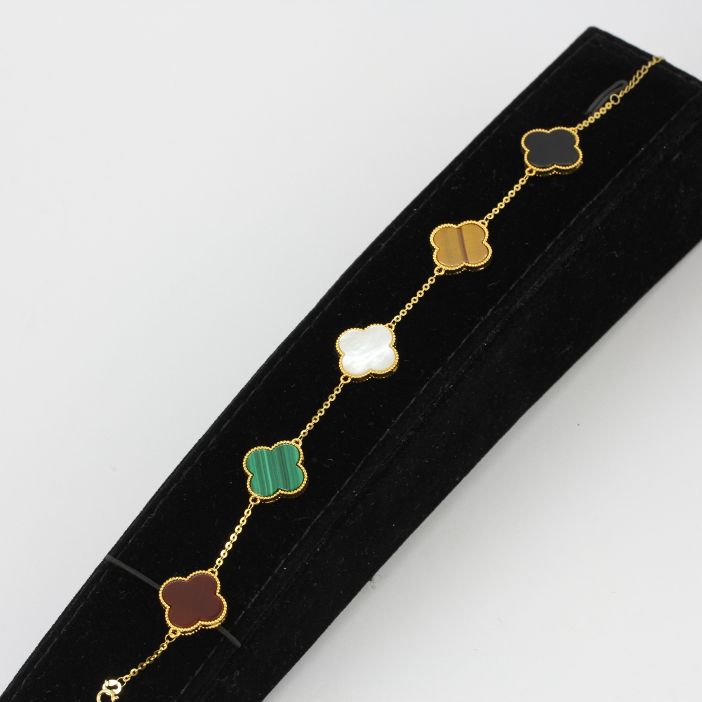 An 18ct yellow gold clover bracelet set with carnelian, malachite, tiger's eye, onyx and mother of - Image 3 of 3