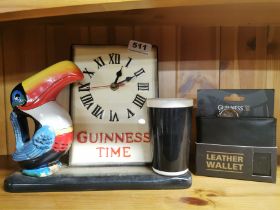 A Guinees advertising clock, H. 21cm and wallet.