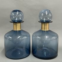 A pair of large factice style shop window display bottles with brass collars, H. 38cm.