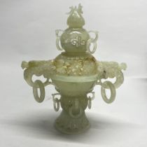 An intricately carved Chinese jade / hardstone censer with integral rings, H. 20cm, a/f to cover.