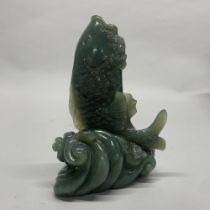 A large Chinese carved jade / hardstone figure of a fish jumping out of the water, H. 16cm.