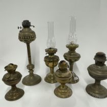 A group of brass oil lamps.