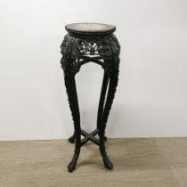A 19thC Chinese carved hardwood and stone topped plant stand, H. 90cm top Dia. 28cm.