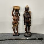 Two large African carved wooden figures with a wooden spear, figure H. 78cm.