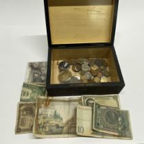 A poker worked wooden box and coin contents.