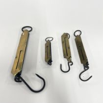 A group of old brass balance scales.