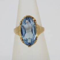 A 9ct yellow gold ring set with a large oval cut blue topaz, stone L. 1.5cm.