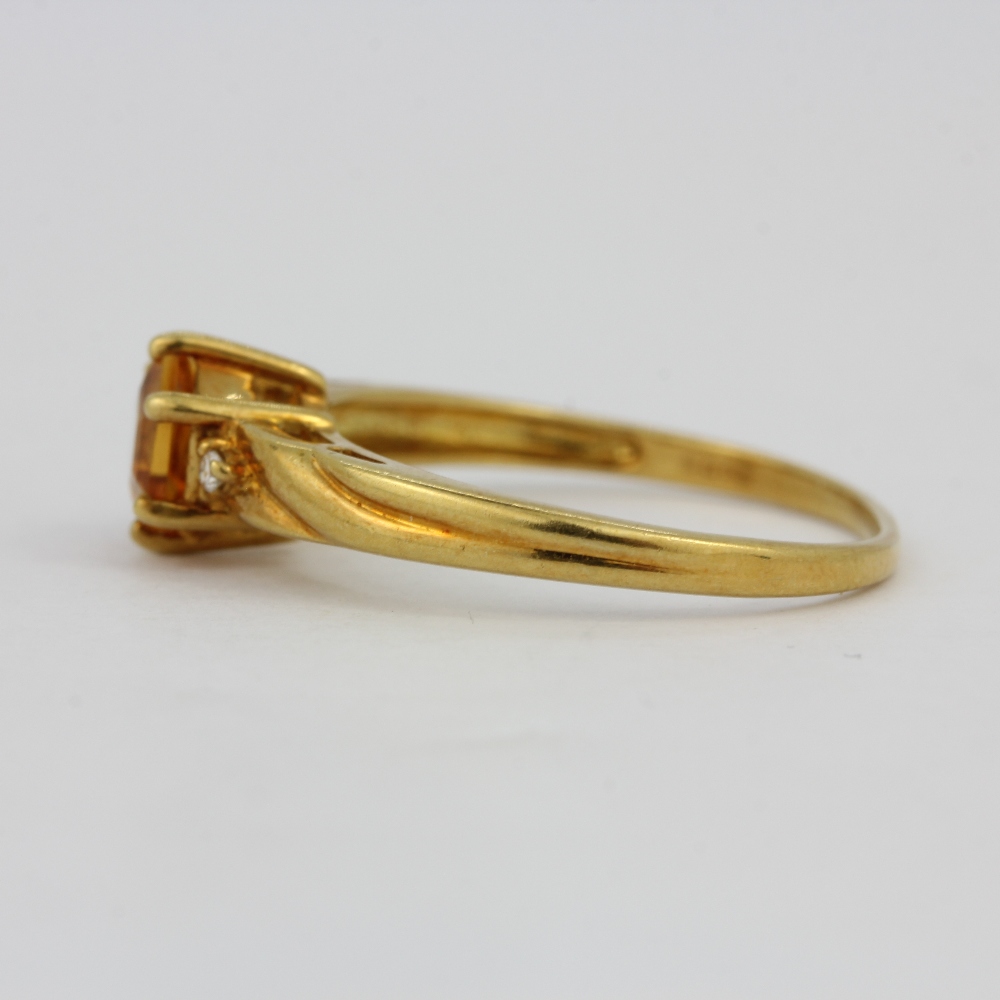 A hallmarked 18ct yellow gold ring set with an hexagonal cut citrine and diamonds, (O). - Image 2 of 2